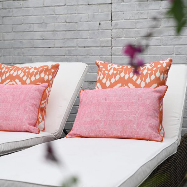 orange outdoor cushion in bold ikat design