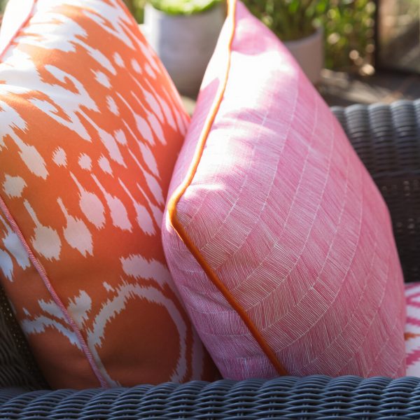 orange outdoor cushion in bold ikat design